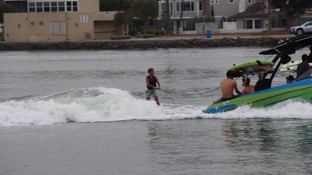 A couple of people riding a jet ski

Description automatically generated