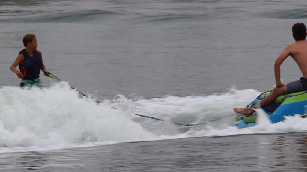 A person on a surfboard in the ocean

Description automatically generated