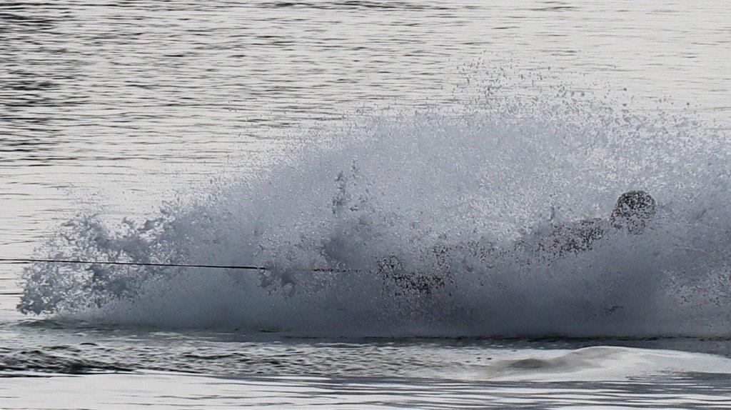 A person surfing in the water

Description automatically generated