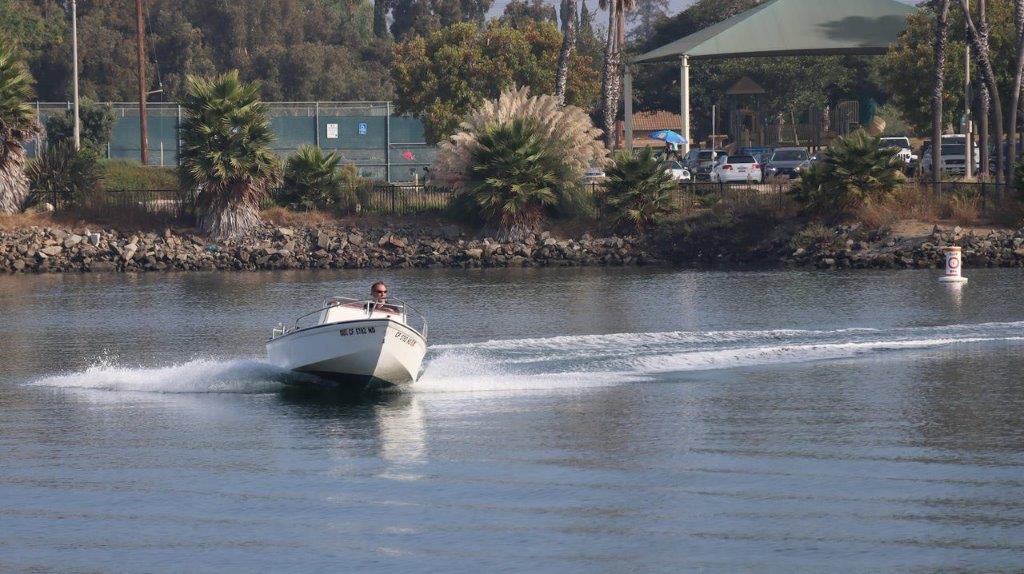 A speedboat on a lake

Description automatically generated